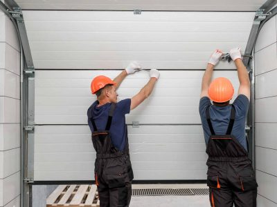 Workers are installing lifting gates of the garage.; Shutterstock ID 1519701983; Purchase Order: Zeus