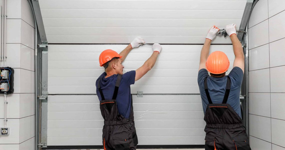 Workers are installing lifting gates of the garage.; Shutterstock ID 1519701983; Purchase Order: Zeus