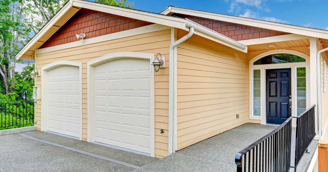 House exterior. Entrance porch with black door  and railings. House with two car garage; Shutterstock ID 230907439; PO: Zeus