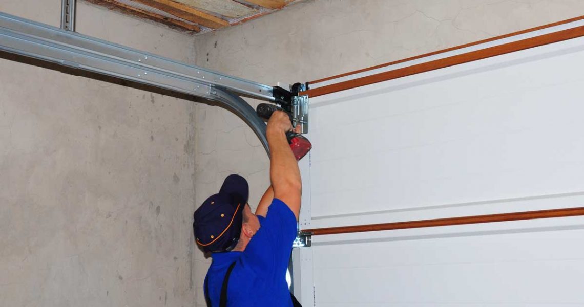 man repairing noisy garage door